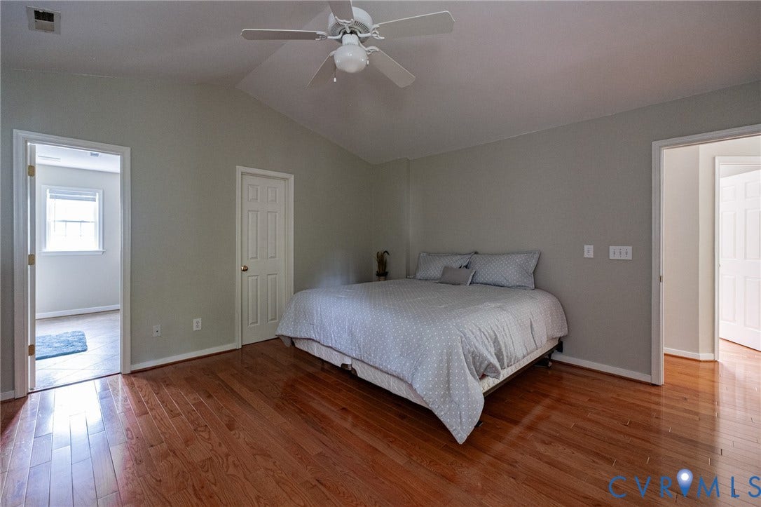 10517 Park Tree Place, Mountain Glen/ Glen Allen, Glen Allen, VA 23060 Spacious interior room featuring warm wood-finish flooring, a vaulted ceiling, and a ceiling fan with integrated lighting