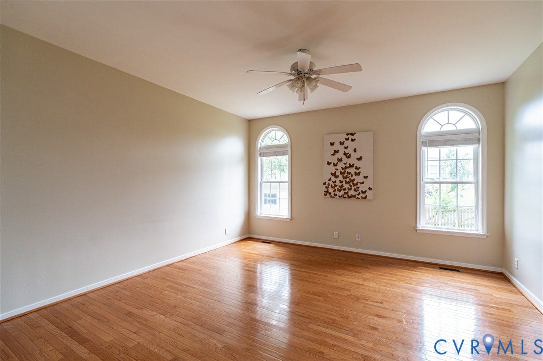 10517 Park Tree Place, Mountain Glen/ Glen Allen, Glen Allen, VA 23060 Spacious second family room featuring hardwood flooring, two arched windows with internal grilles, a ceiling fan, and light-toned walls
