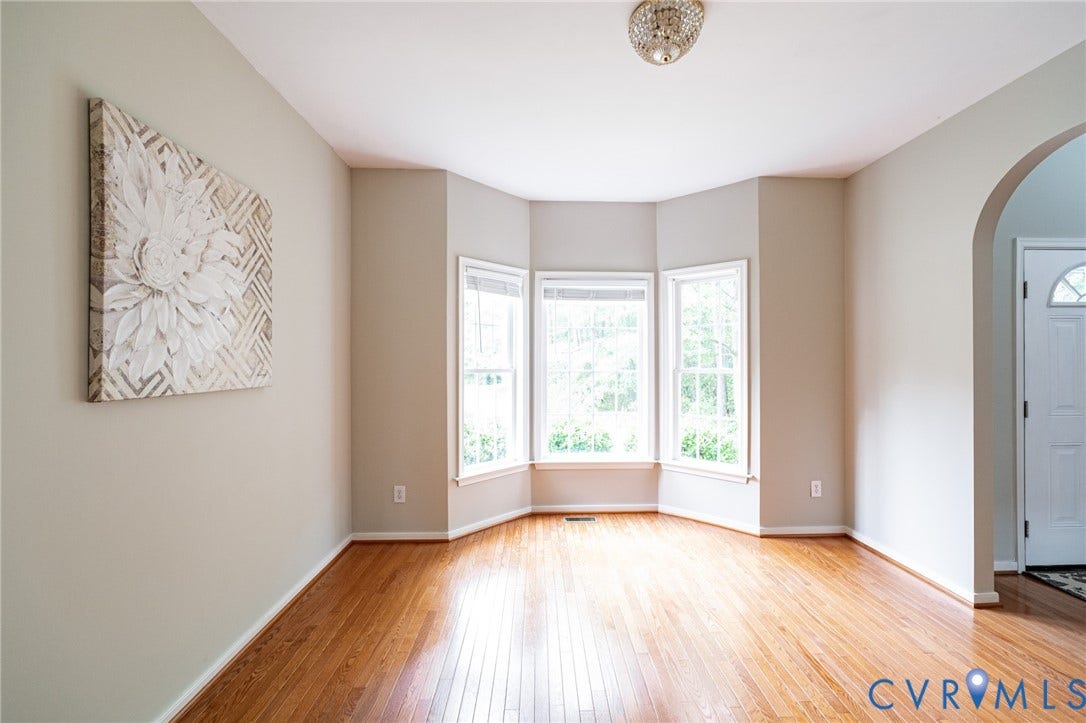10517 Park Tree Place, Mountain Glen/ Glen Allen, Glen Allen, VA 23060 Light wood-finish flooring with a bay window feature, arched doorway, and decorative ceiling light fixture