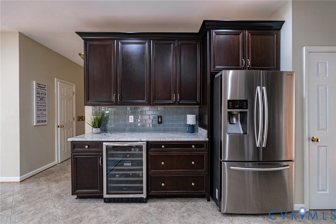 10517 Park Tree Place, Mountain Glen/ Glen Allen, Glen Allen, VA 23060 Built-in beverage cooler beneath a light-toned countertop, complemented by dark wood cabinetry