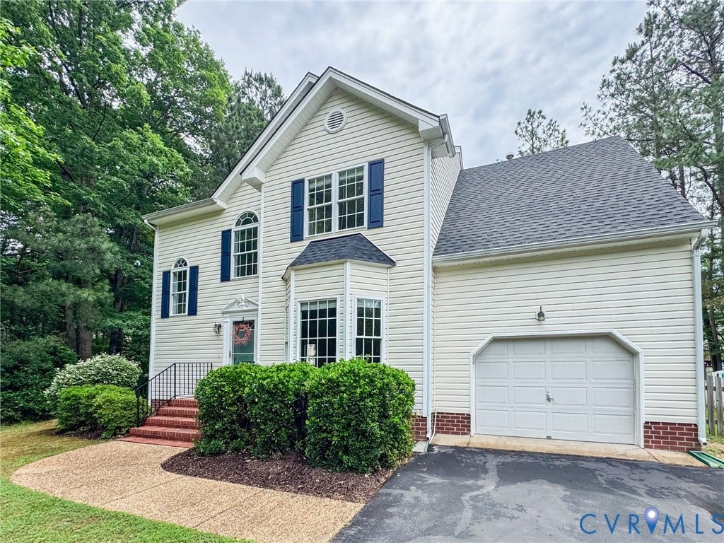 10517 Park Tree Place, Mountain Glen/ Glen Allen, Glen Allen, VA 23060 Light-toned siding exterior featuring a multi-pane bay window, dark blue window shutters, and a single-car garage