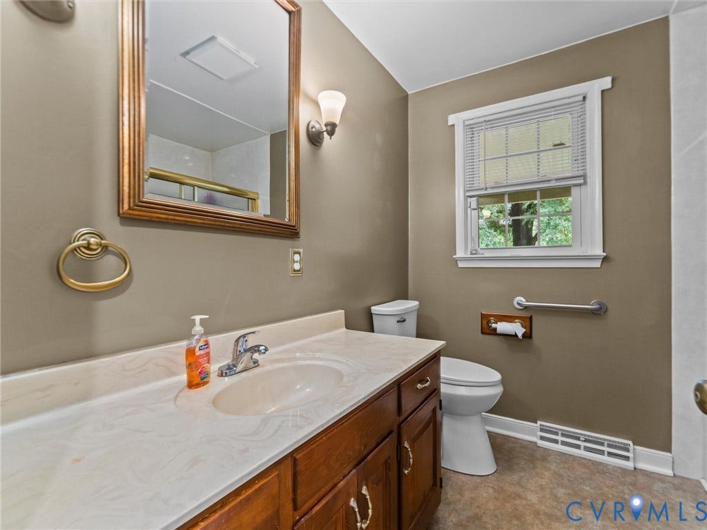 3420 Goodwyn Road, Powhatan, VA 23139 Bathroom featuring a wood-finish vanity with a single basin and white countertop