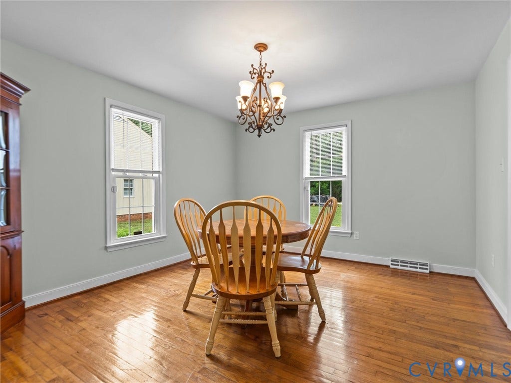 3420 Goodwyn Road, Powhatan, VA 23139 Dining area featuring wood-finish flooring, light gray wall paint, and a traditional chandelier