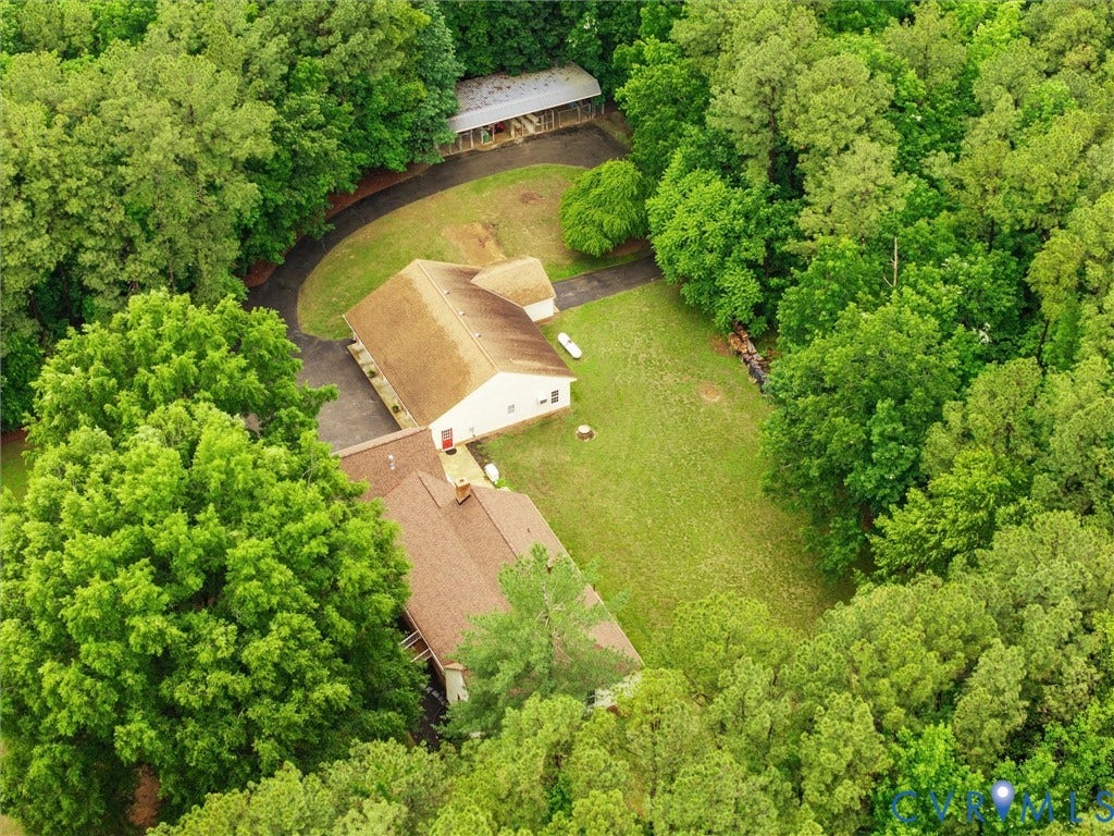 3420 Goodwyn Road, Powhatan, VA 23139 Expansive property featuring two distinct structures, a curving driveway, a large grassy area, and mature perimeter trees