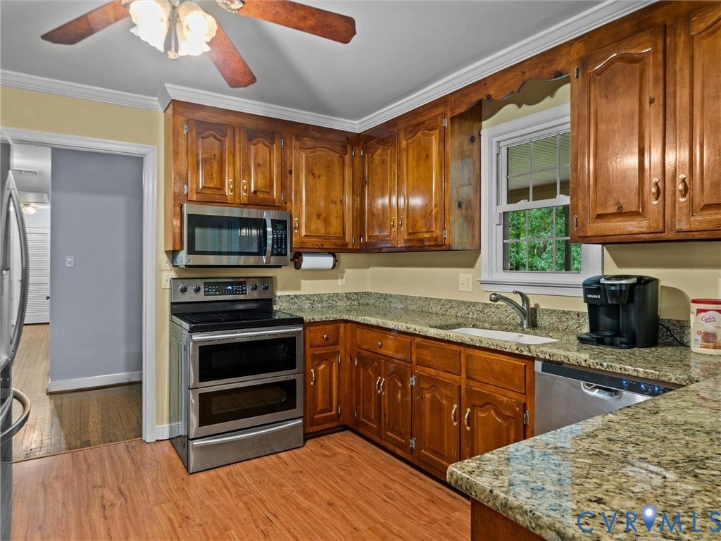 3420 Goodwyn Road, Powhatan, VA 23139 Kitchen featuring wood-finish flooring, wood cabinetry, granite countertops, and stainless steel appliances including a double oven range, microwave, and dishwasher