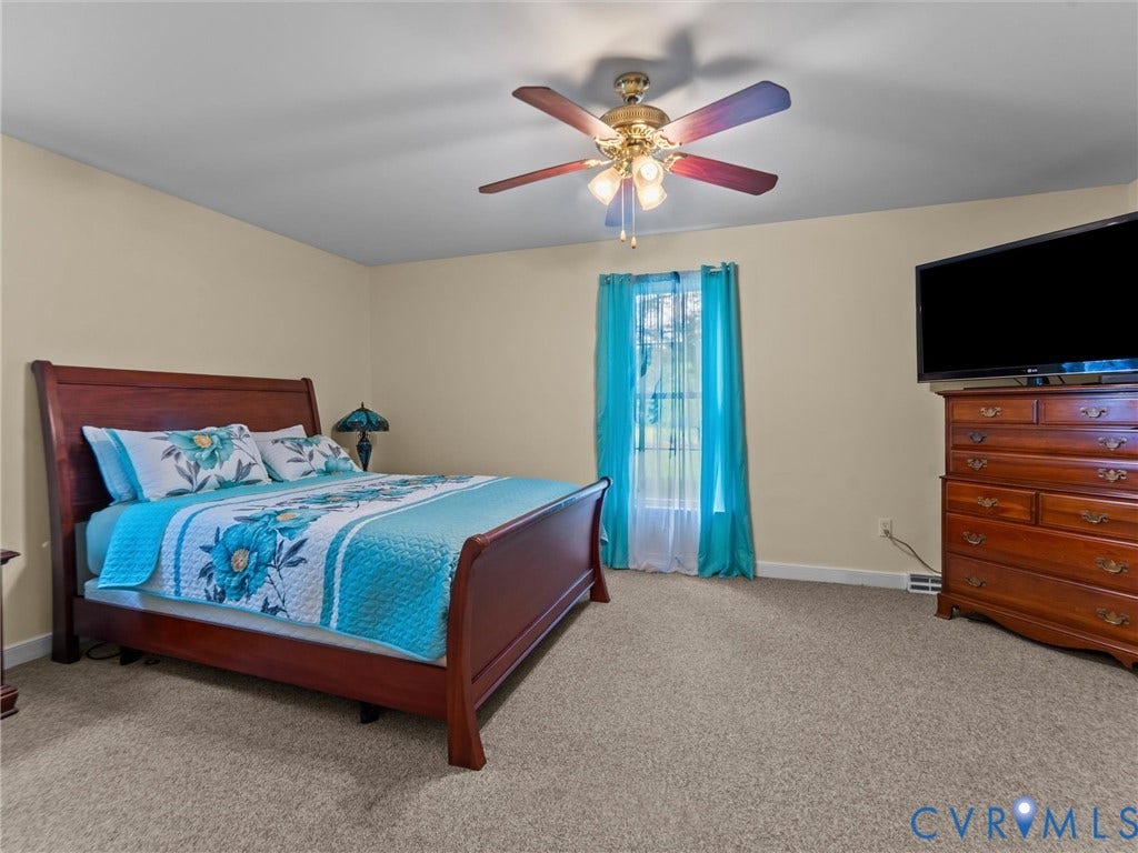 3420 Goodwyn Road, Powhatan, VA 23139 Carpeted room featuring a ceiling fan with integrated lighting, a window with vertical blinds, and neutral wall tones