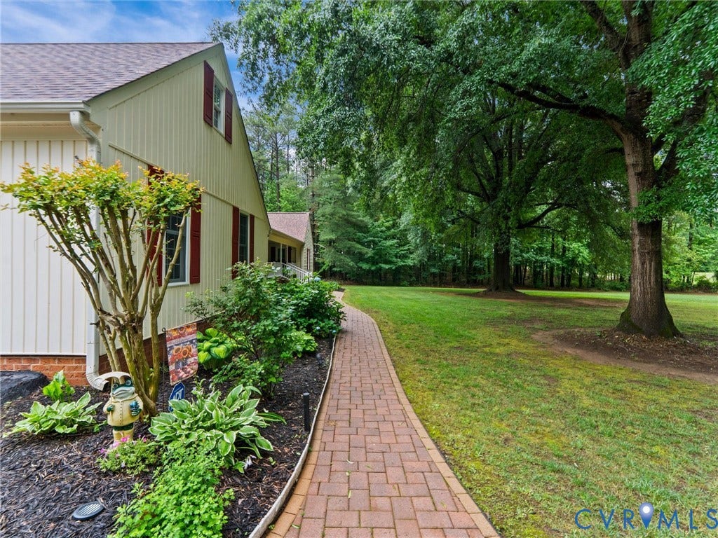3420 Goodwyn Road, Powhatan, VA 23139 Exterior siding in a light neutral tone with contrasting red shutters