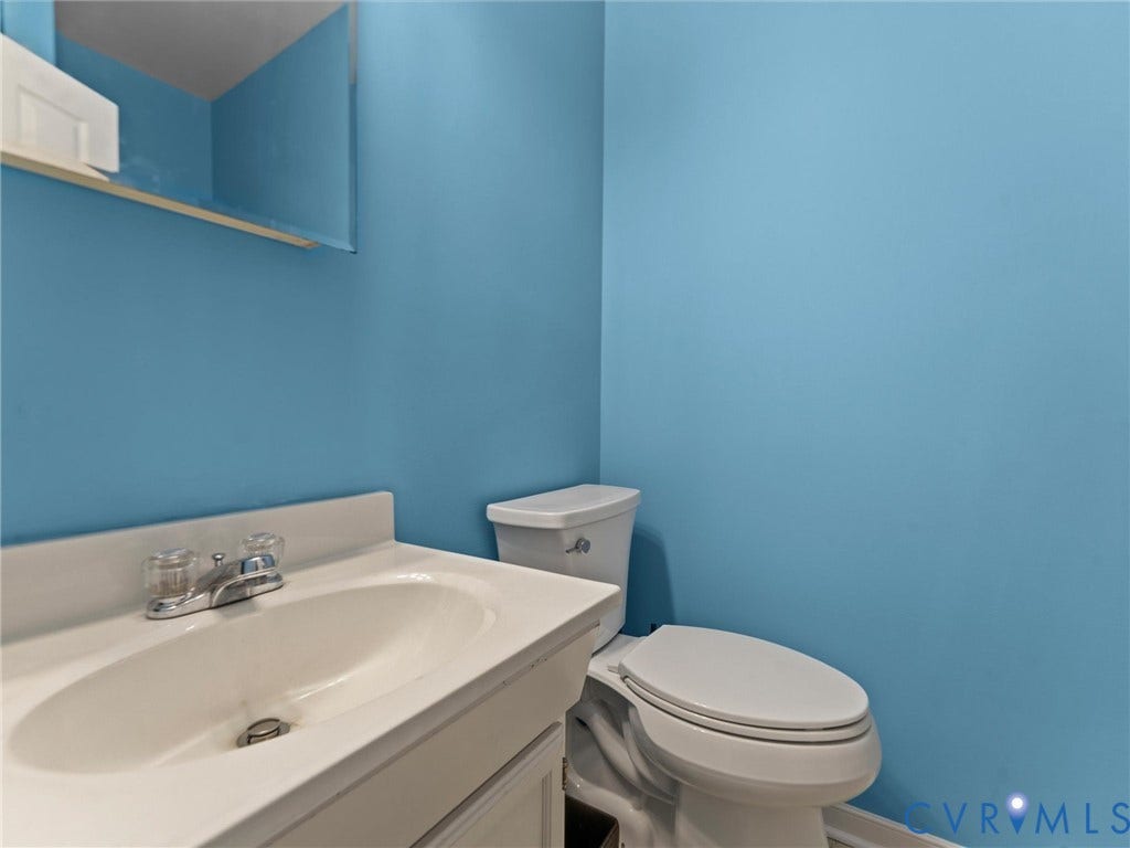 3420 Goodwyn Road, Powhatan, VA 23139 Flex-space bath with white ceramic vanity with integrated sink, chrome faucet, and white two-piece toilet. Tub/shower combination.