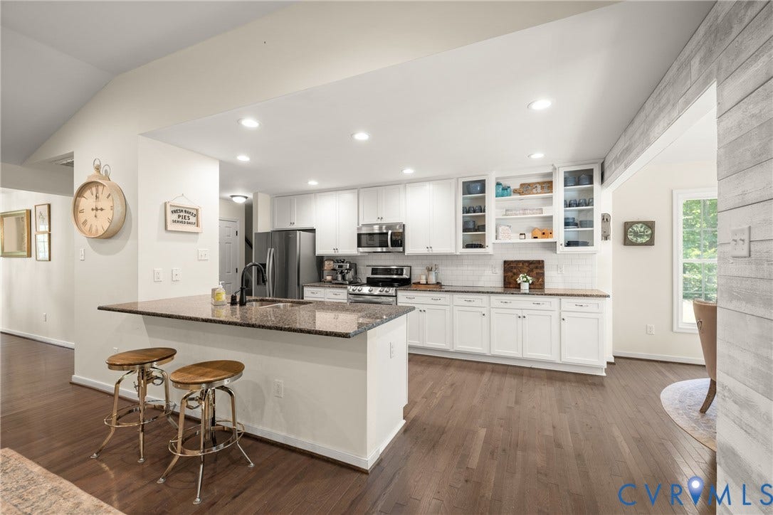 2803 Preston Park Way, Preston Park, Sandy Hook, VA 23153 Kitchen loaded with white cabinets, stainless steel appliances, granite counters, bar stool area, breakfast nook, pantry and wood floors.