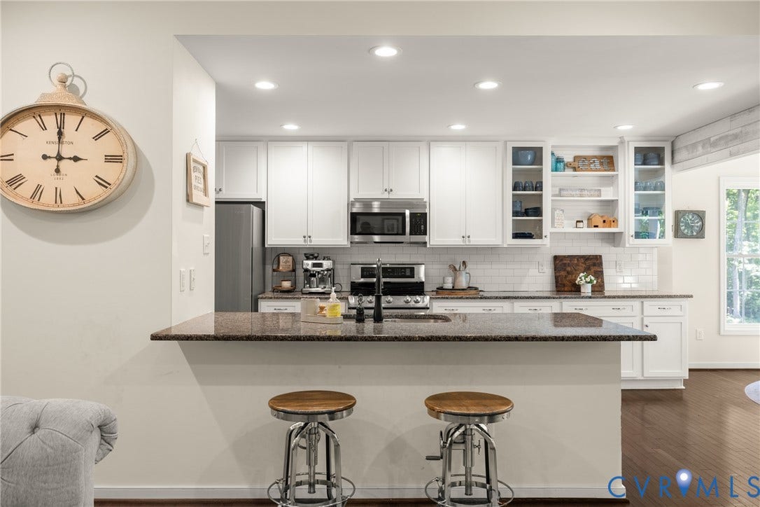 2803 Preston Park Way, Preston Park, Sandy Hook, VA 23153 Kitchen loaded with white cabinets, stainless steel appliances, granite counters, bar stool area, breakfast nook, pantry and wood floors.