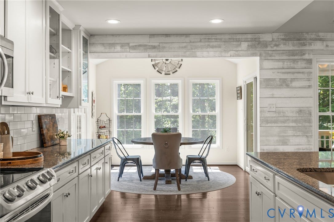 2803 Preston Park Way, Preston Park, Sandy Hook, VA 23153 Kitchen loaded with white cabinets, stainless steel appliances, granite counters, bar stool area, breakfast nook, pantry and wood floors.