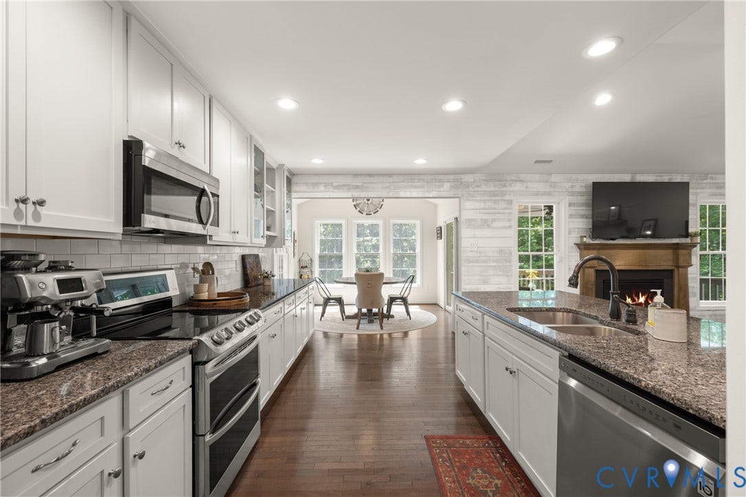 2803 Preston Park Way, Preston Park, Sandy Hook, VA 23153 Kitchen loaded with white cabinets, stainless steel appliances, granite counters, bar stool area, breakfast nook, pantry and wood floors.