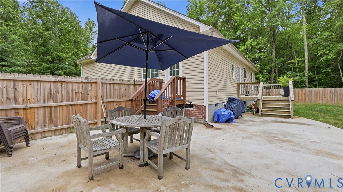 2406 Emanuel Church Road, Powhatan, VA 23139 Concrete patio featuring a privacy fence, exterior siding, and a multi-level wood deck