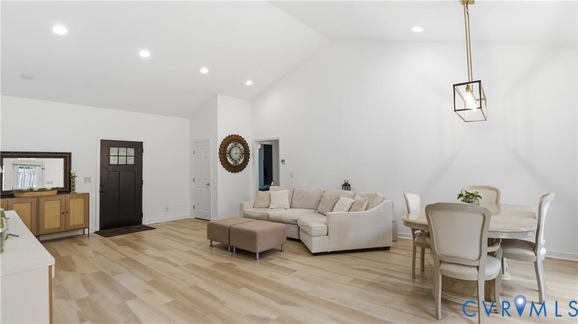 2406 Emanuel Church Road, Powhatan, VA 23139 Vaulted ceilings highlight this open concept living space, featuring recessed lighting and wood-finish flooring