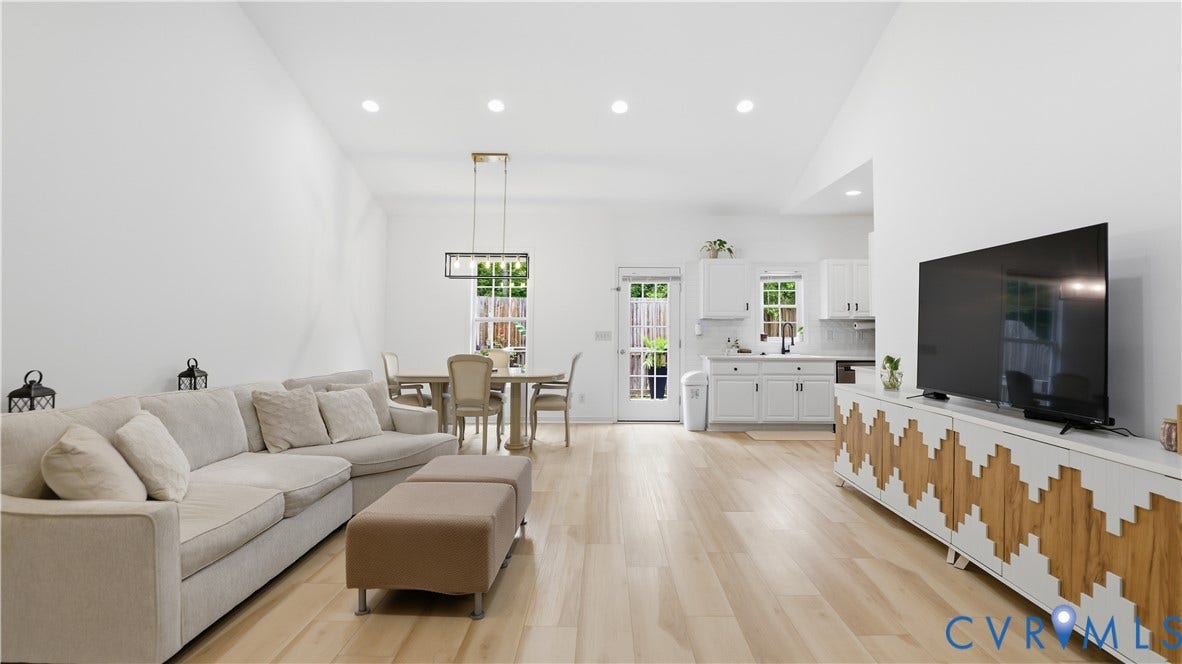 2406 Emanuel Church Road, Powhatan, VA 23139 Open-concept living space featuring wood-finish flooring, recessed lighting, and high vaulted ceilings