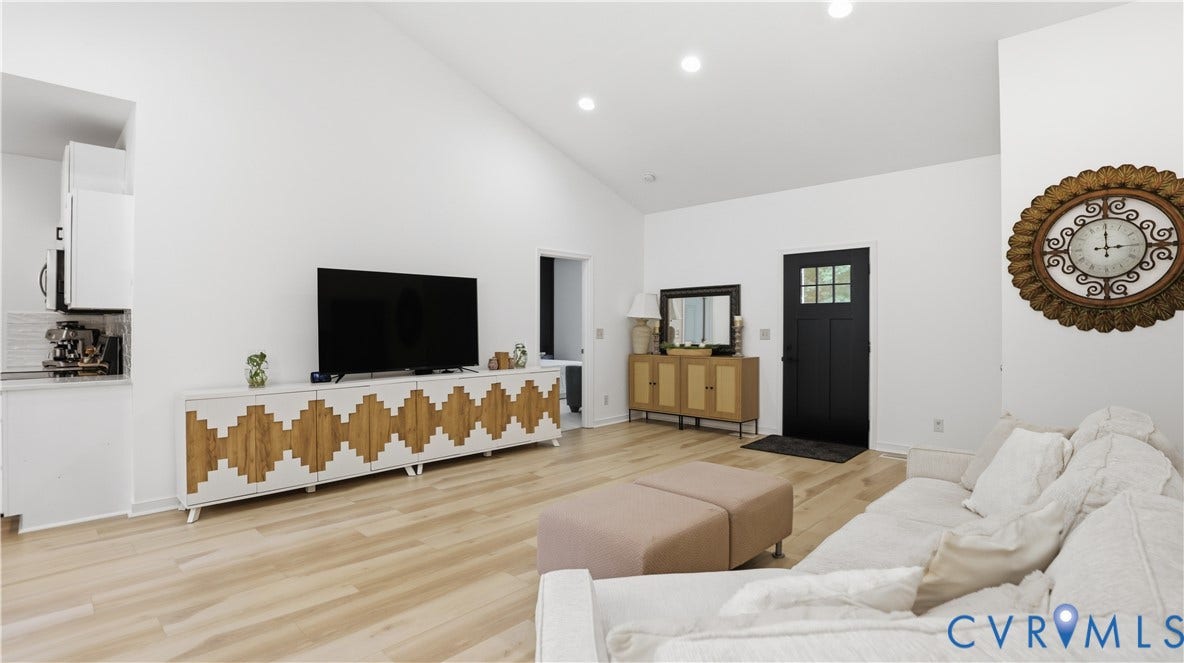 2406 Emanuel Church Road, Powhatan, VA 23139 Spacious open-concept living area featuring vaulted ceilings, light wood-finish flooring, and recessed lighting
