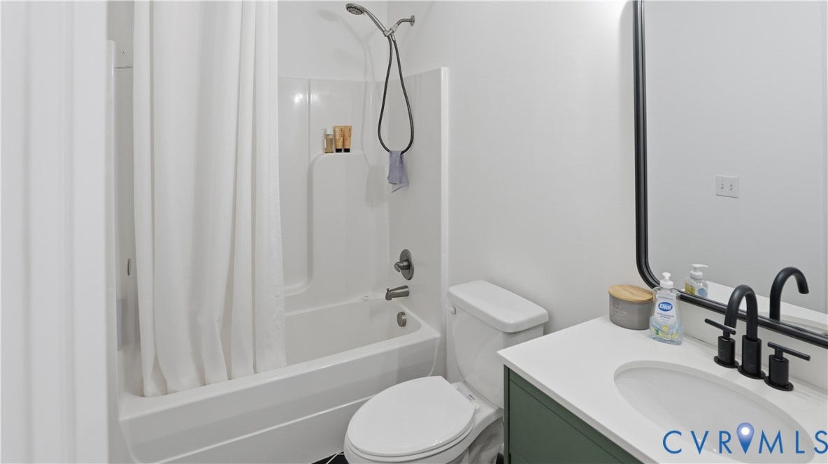 2406 Emanuel Church Road, Powhatan, VA 23139 Bathroom featuring a white tub/shower combination with a shower curtain, white toilet, and a vanity with a white countertop