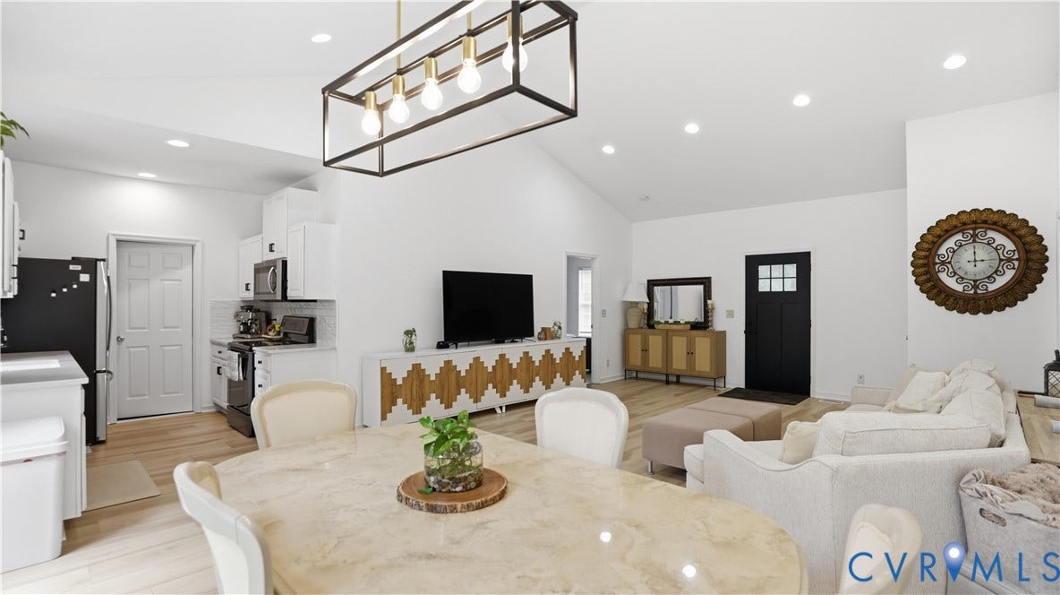 2406 Emanuel Church Road, Powhatan, VA 23139 Open-concept living space featuring wood-finish flooring, recessed lighting, and a vaulted ceiling
