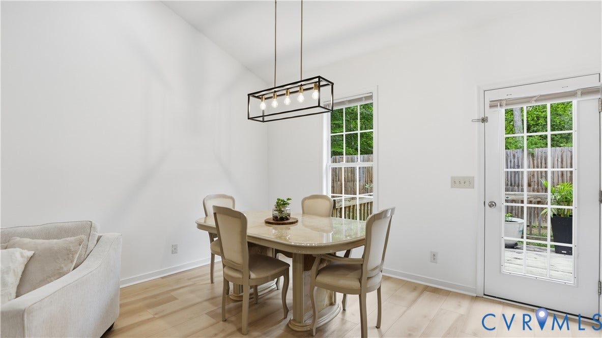 2406 Emanuel Church Road, Powhatan, VA 23139 Dining area with light wood-finish flooring, vaulted ceilings, and a contemporary linear chandelier