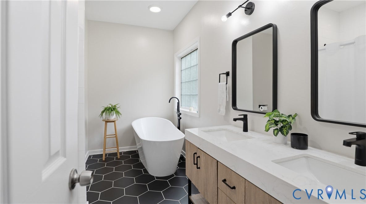 2406 Emanuel Church Road, Powhatan, VA 23139 Bathroom featuring a freestanding soaking tub, hex tile flooring, dual vanity with undermount sinks, and matte black fixtures