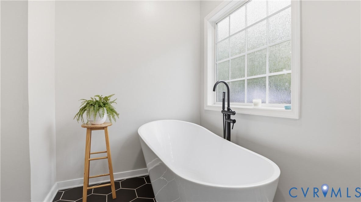 2406 Emanuel Church Road, Powhatan, VA 23139 White freestanding bathtub with a contemporary matte black floor-mounted faucet