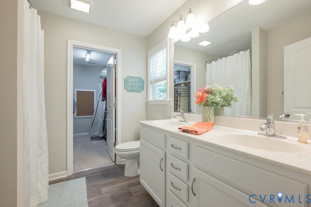 1046 Orchid Road, Mineral, VA 23117 Primary Bathroom has raised double vanity, tub/shower combo, LVT flooring and Walk In Closet.