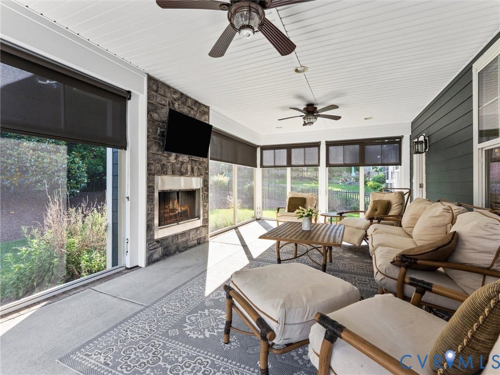 3 Season porch w/ vinyl windows, custom shades and fireplace