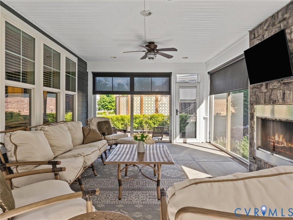 3 Season porch w/ vinyl windows, custom shades and fireplace