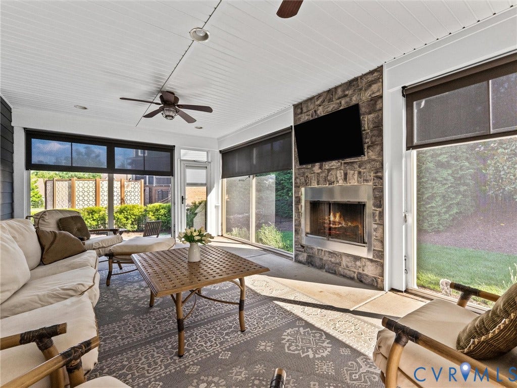 3 Season porch w/ vinyl windows, custom shades and fireplace