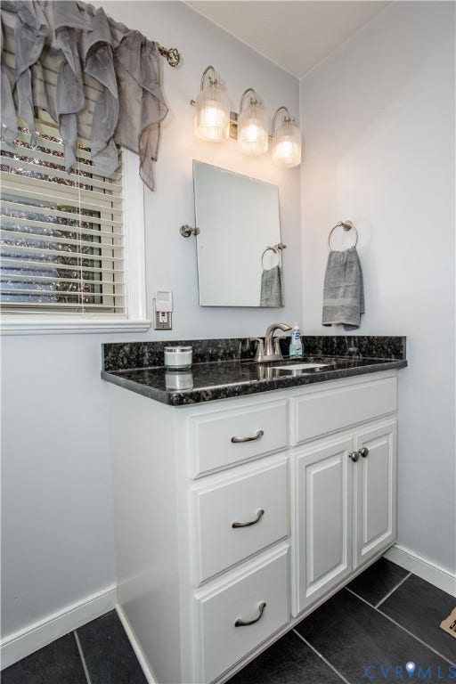 4512 Wraywood Avenue, Preston Place, Chester, VA 23831 White vanity with dark countertop, brushed nickel fixtures, and rectangular mirror