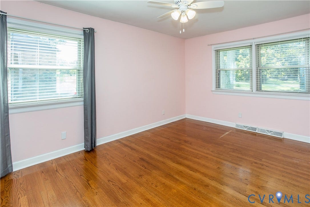 4512 Wraywood Avenue, Preston Place, Chester, VA 23831 Hardwood flooring, two windows with blinds, white trim, and a ceiling fan with integrated lighting