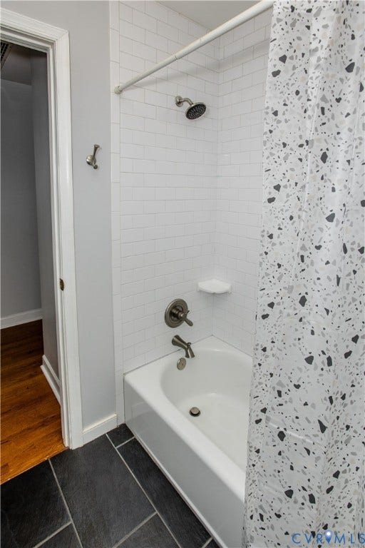 4512 Wraywood Avenue, Preston Place, Chester, VA 23831 White subway tile shower surround with brushed nickel fixtures and a white bathtub, complemented by dark plank-style floor tiles