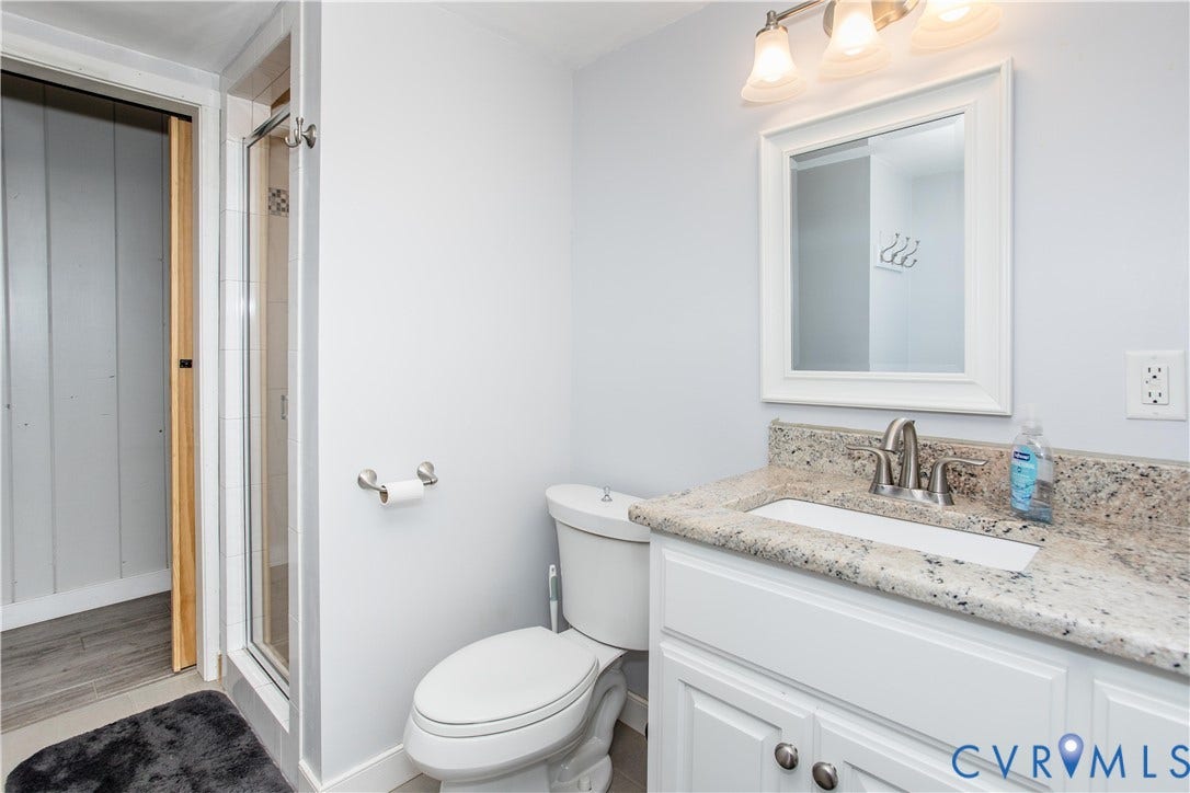 4512 Wraywood Avenue, Preston Place, Chester, VA 23831 White vanity with dual cabinet doors, light-toned countertop, and undermount sink
