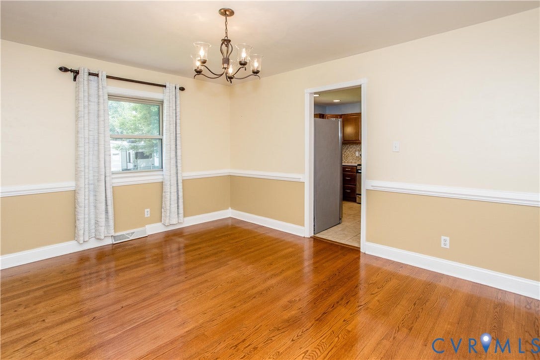 4512 Wraywood Avenue, Preston Place, Chester, VA 23831 Wood-finish flooring, two-tone wall paint with chair rail molding, and a five-light chandelier
