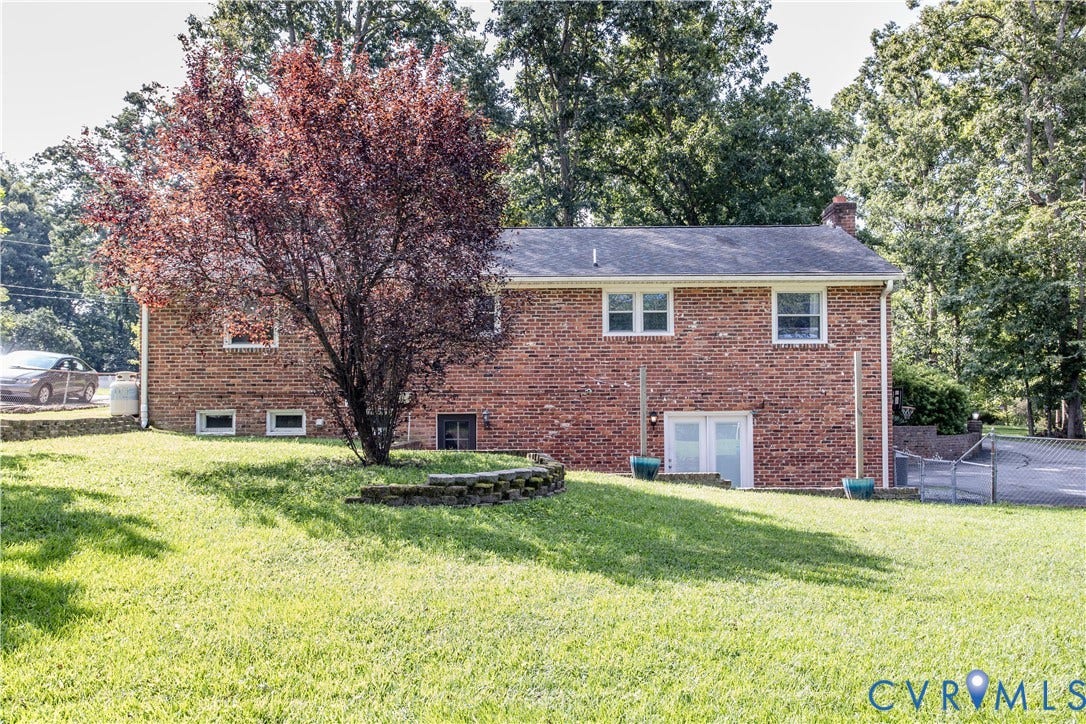 4512 Wraywood Avenue, Preston Place, Chester, VA 23831 Brick exterior with white frame windows, a mature tree, and a sloped lawn