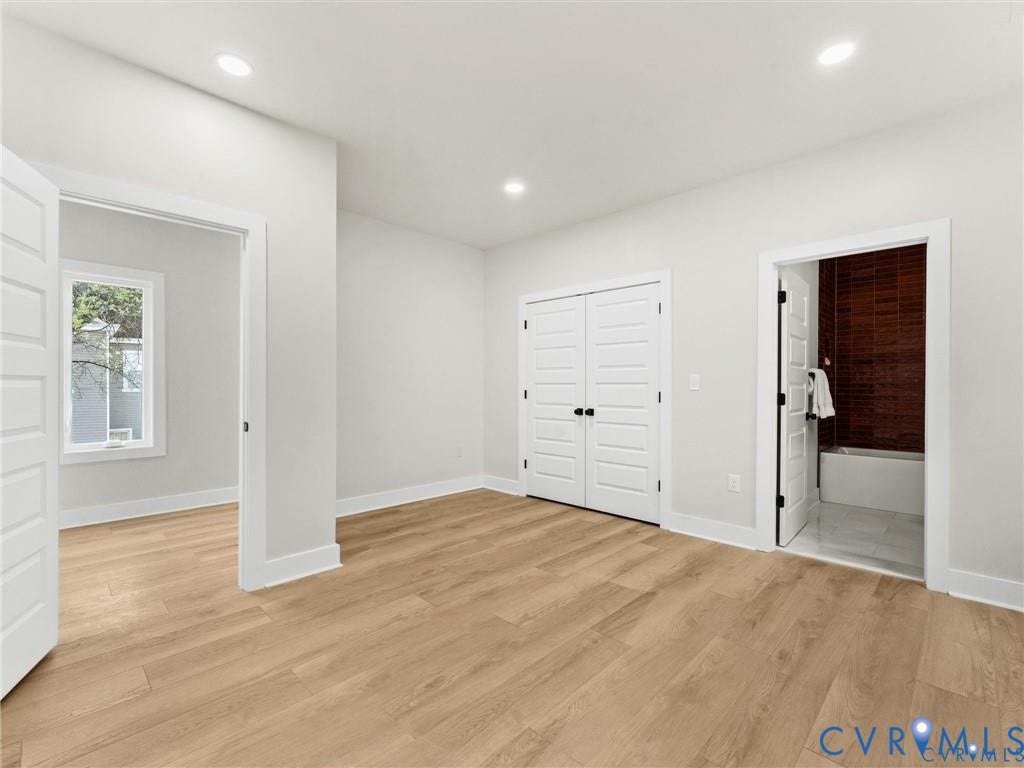 2200 3rd Avenue, Northside, Richmond, VA 23222 Unfurnished bedroom featuring light wood-type flooring, ensuite bath, recessed lighting, and a closet
