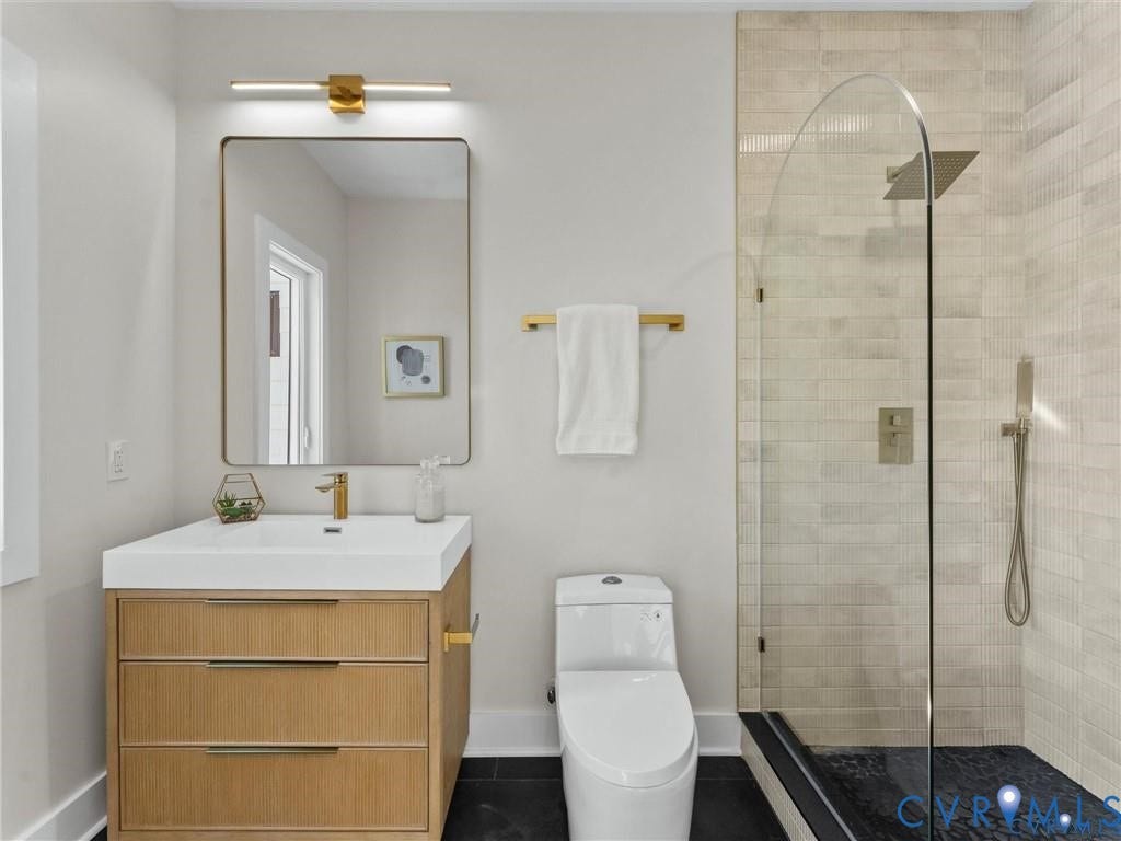 2200 3rd Avenue, Northside, Richmond, VA 23222 Full bath with vanity, a walk in shower, and dark tile patterned floors