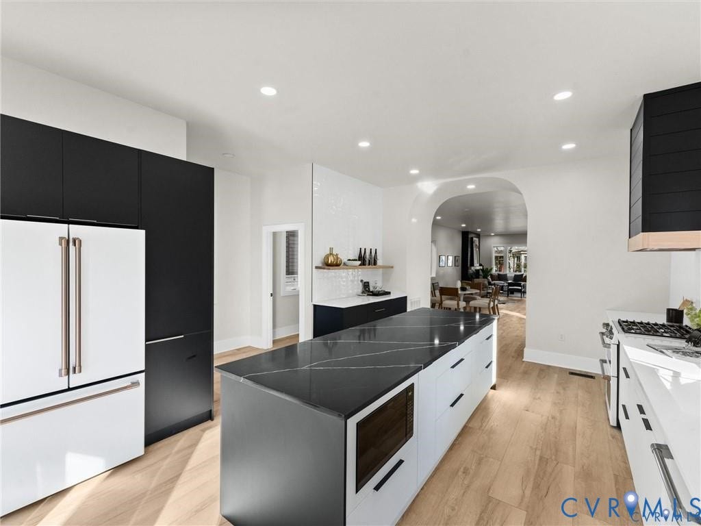2200 3rd Avenue, Northside, Richmond, VA 23222 Kitchen with dark cabinetry, modern cabinets, white appliances, arched walkways, and recessed lighting