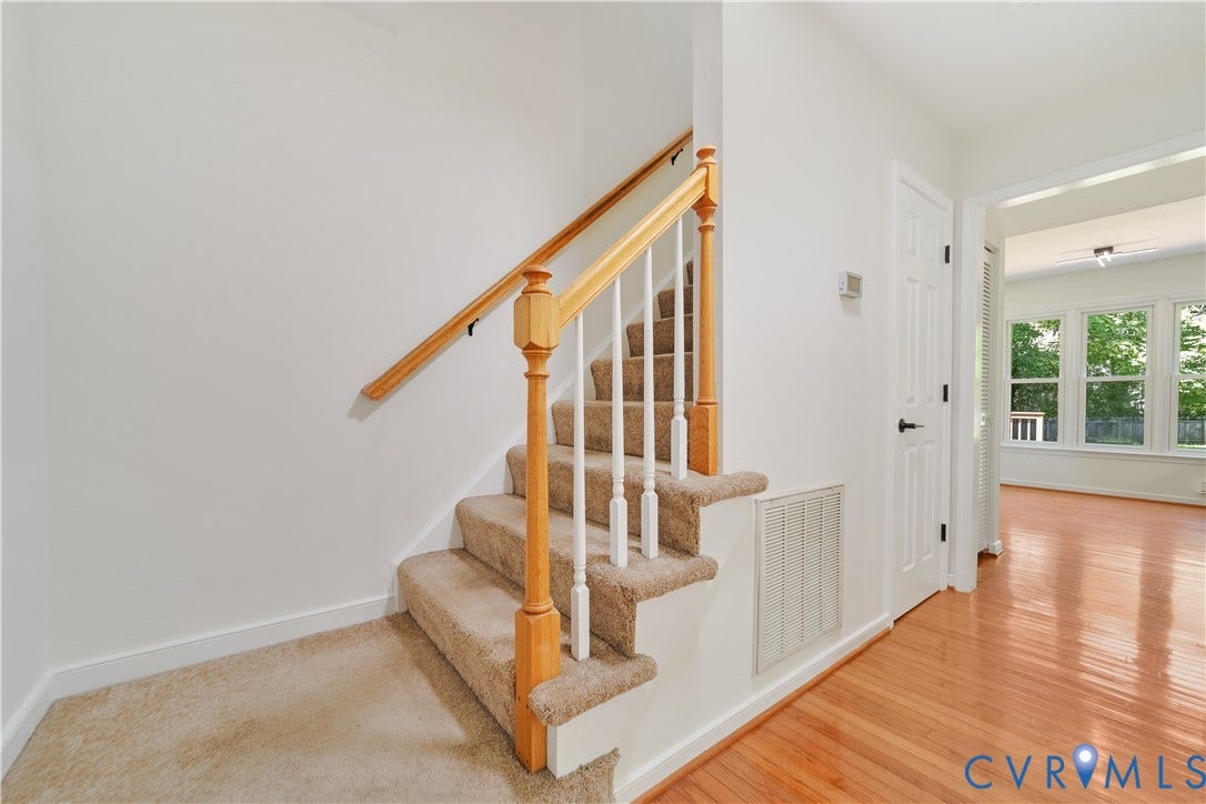 11060 Forest Trace Way, Forest Trace, Glen Allen, VA 23059 Carpeted staircase with wood handrail, white balusters, and a solid white door