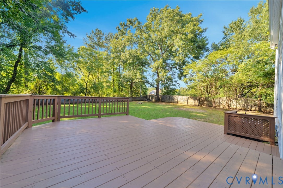 11060 Forest Trace Way, Forest Trace, Glen Allen, VA 23059 Expansive wood-finish deck with railing, opening to a grass lawn and mature trees