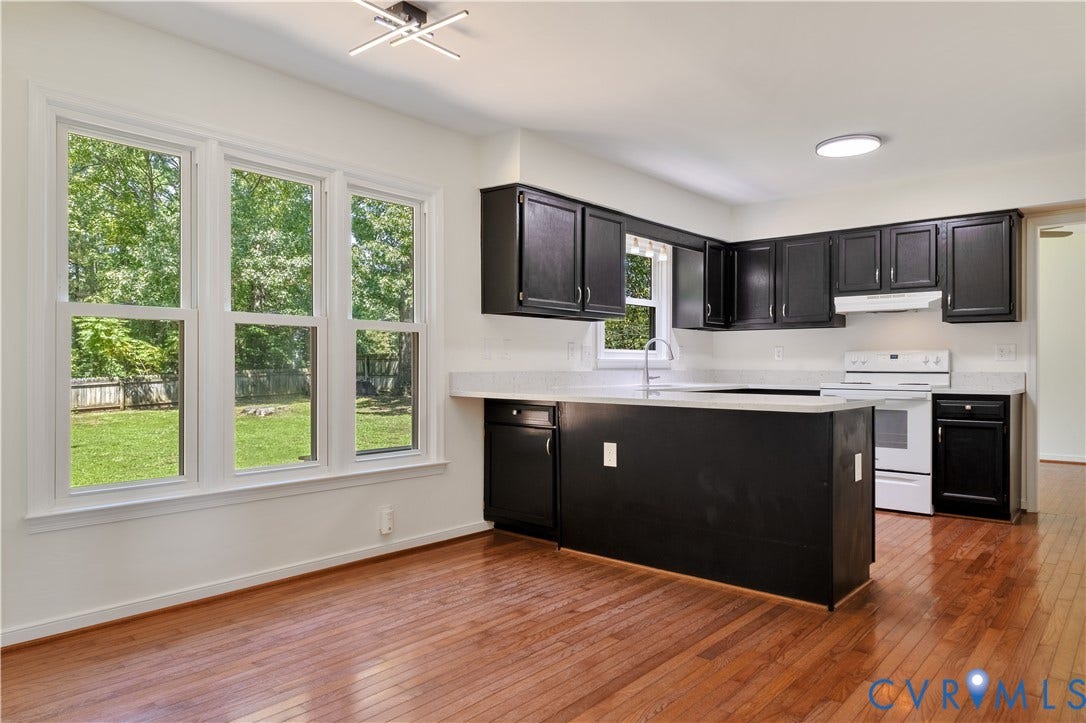 11060 Forest Trace Way, Forest Trace, Glen Allen, VA 23059 Kitchen with dark wood-finish cabinetry, light countertops, and an integrated island