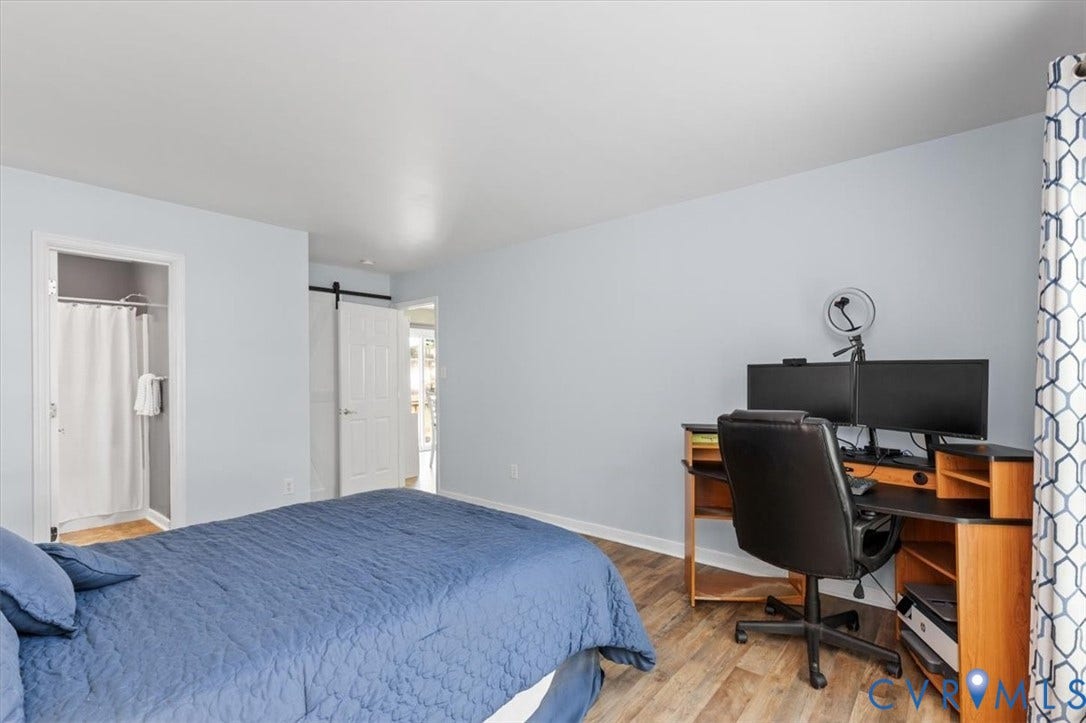 1st Floor Primary Ensuite with attached bath and walk in closet behind the barn door.