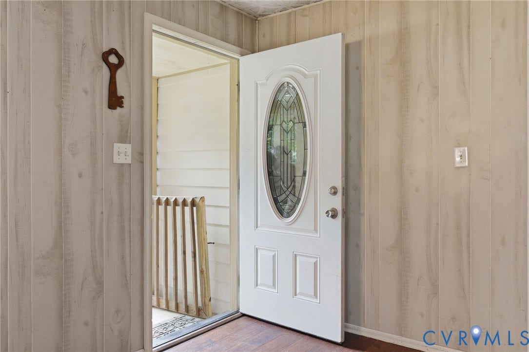 2914 Janet Lane, Powhatan, VA 23139 Entryway featuring wood-finish wall paneling and dark wood-finish flooring