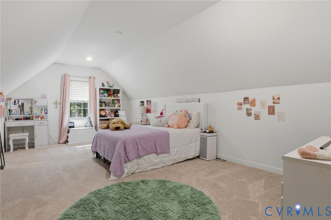 upstairs spacious bedroom with walk-in closet and carpeting