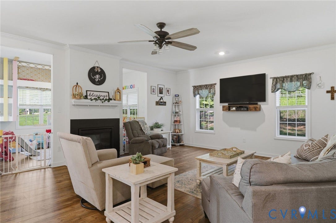 Family room with double-sided gas fireplace, hardwood floors, recessed lighting
