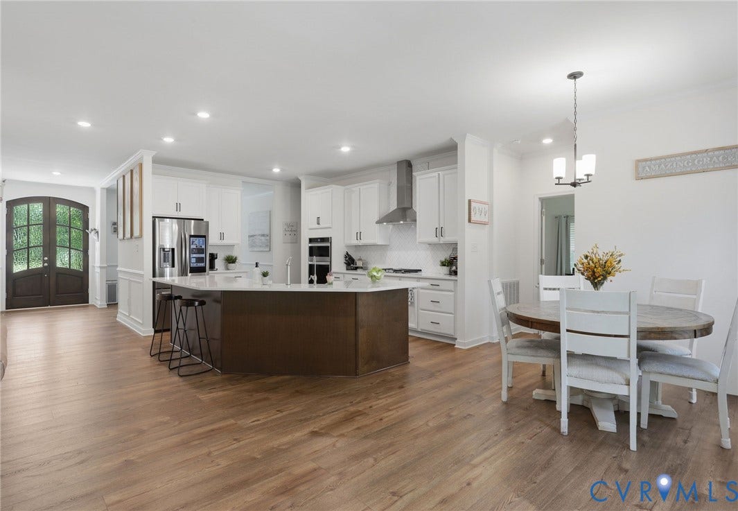 Open floor plan looking into eat in kitchen and bar area