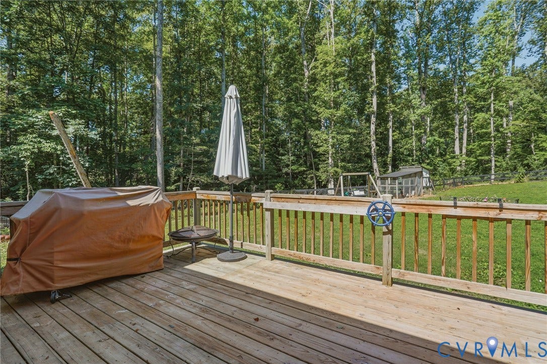 back deck off of kitchen with steps to fenced in backyard