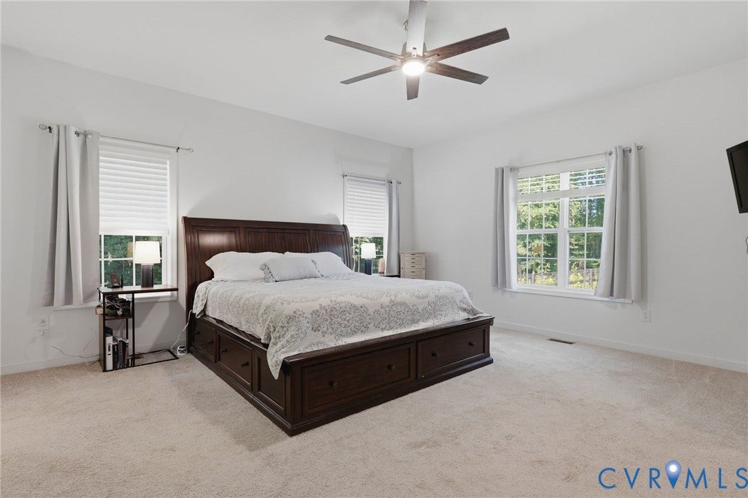 spacious primary bedroom on main level, with walk-in closets and ensuite bath