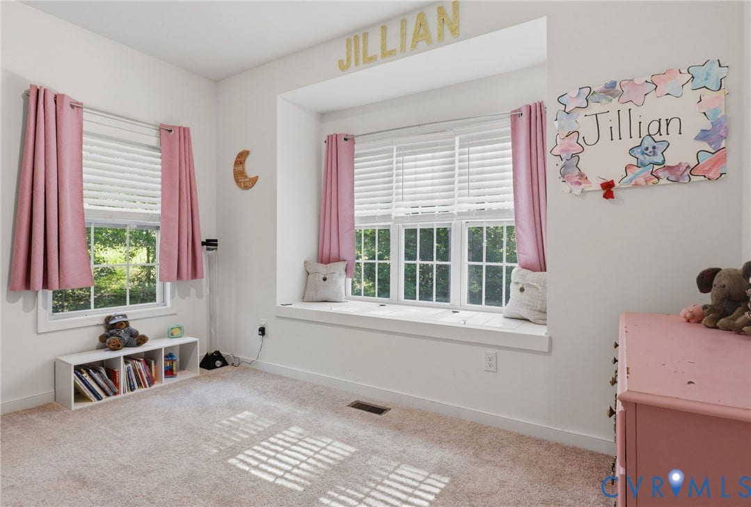 large bedroom with window seat, storage on main level