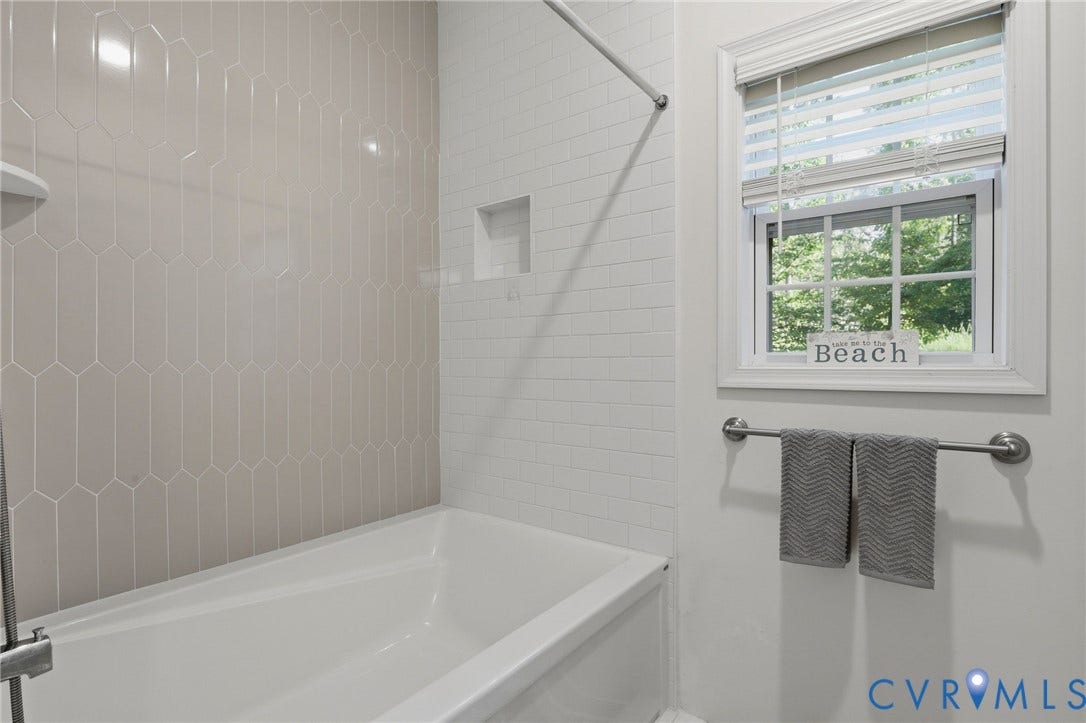 large bathtub with ceramic tile
